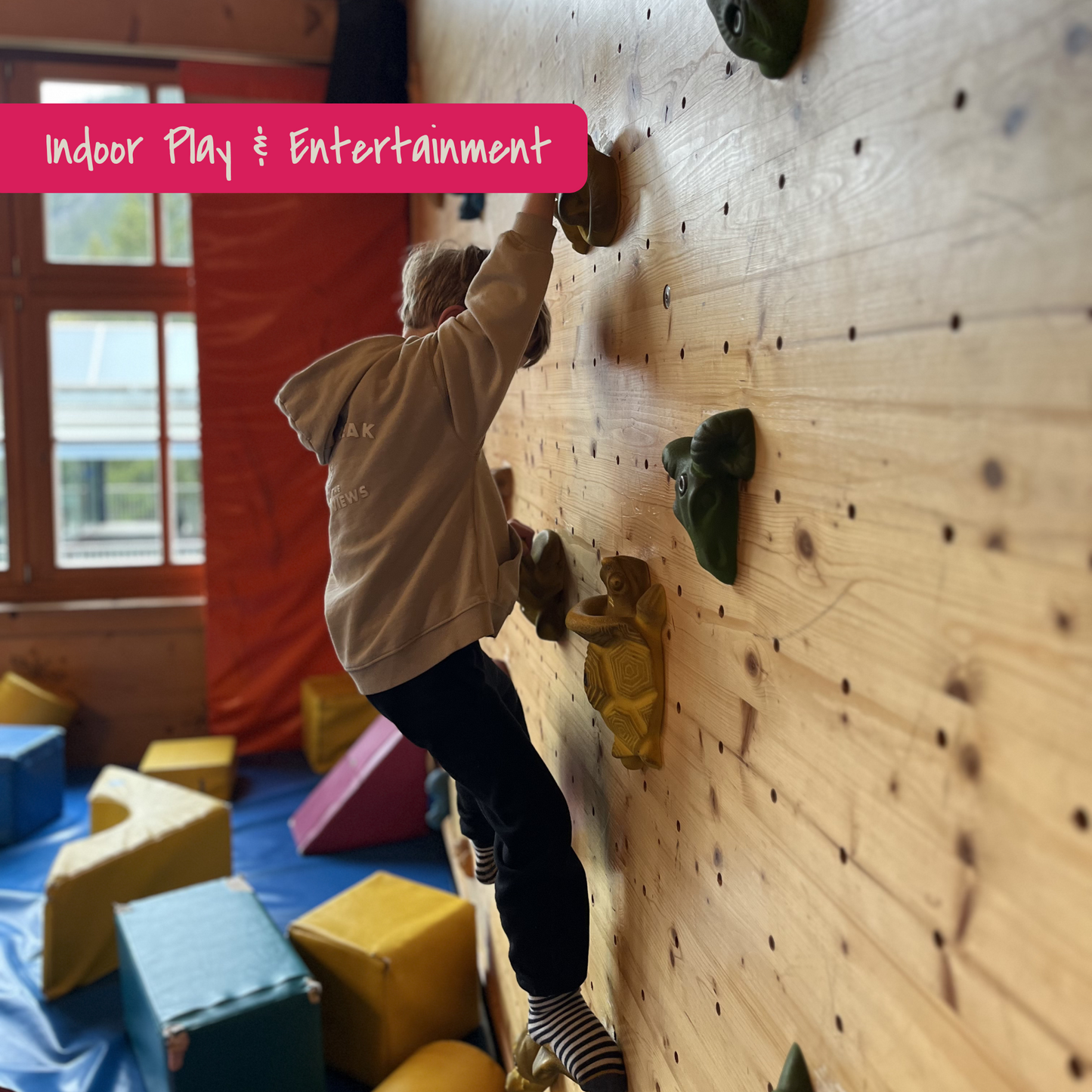 Child on climbing wall on indoor playground in Vorarlberg, Austria. Picture of KidsTravelAdventures.