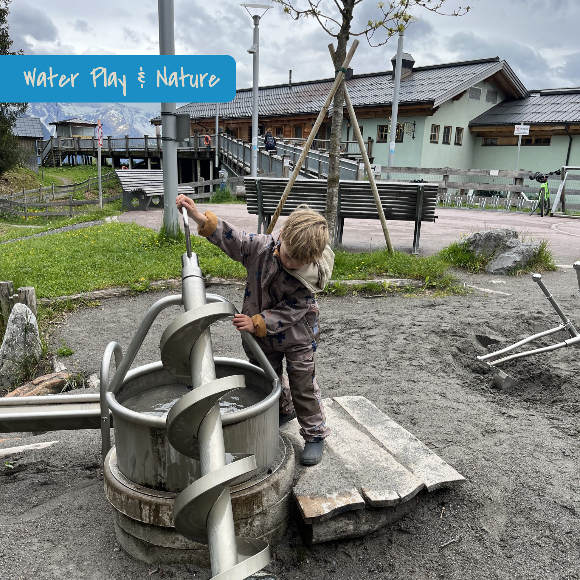 Child playing on naturalized playground with water on Muttersberg in Vorarlberg, Austria. Picture of KidsTravelAdventures.